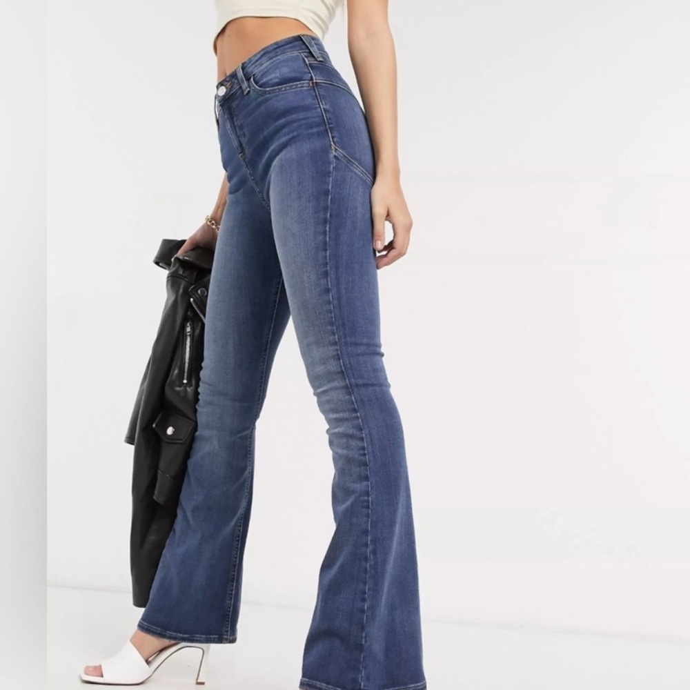 ASOS DESIGN Petite High Rise Lift and Contour Flare Jeans in Midwash